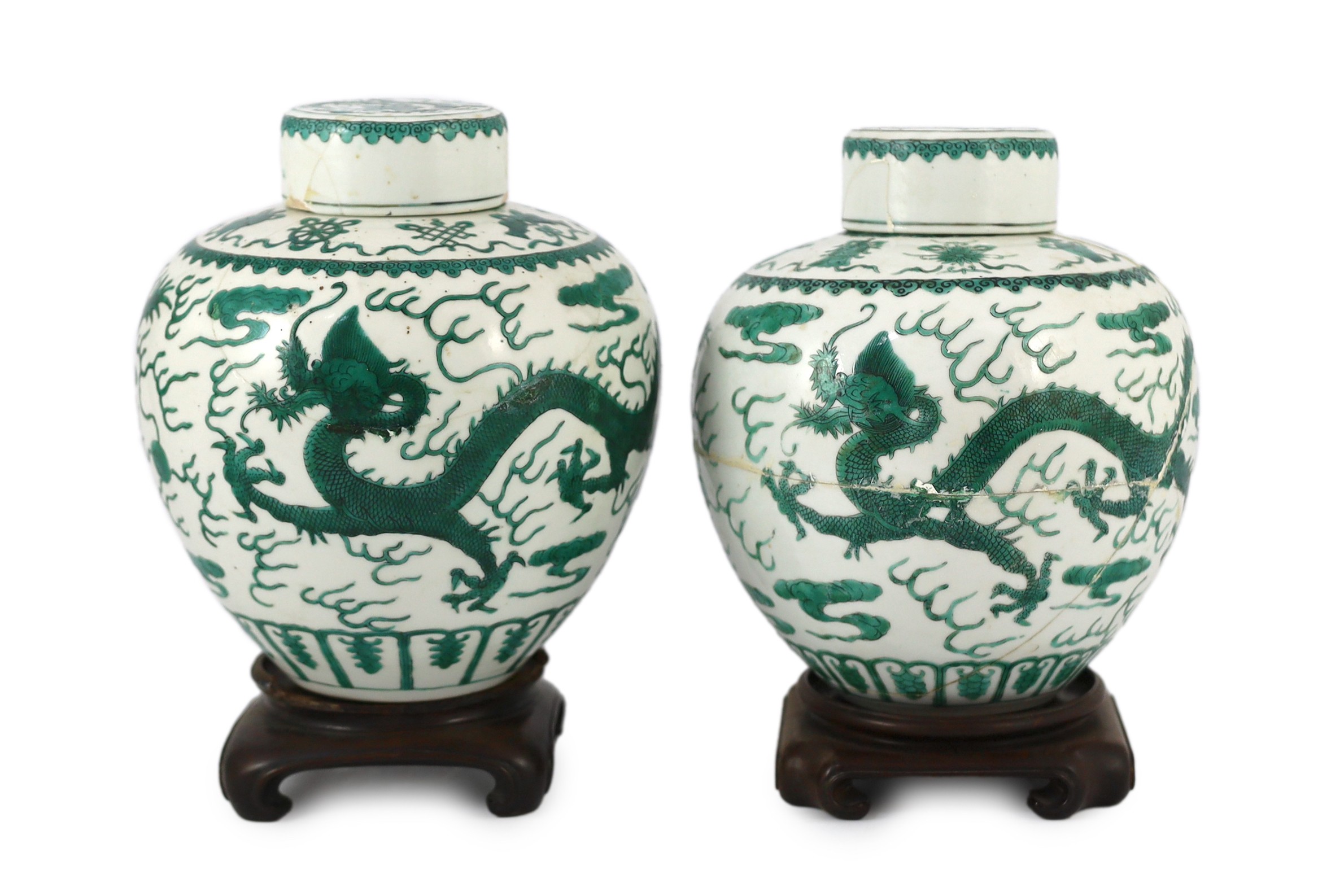 Two similar Chinese green enamelled ‘dragon’ jars and covers, Daoguang mark and period (1821-50), 21.5cm high, damaged and repaired